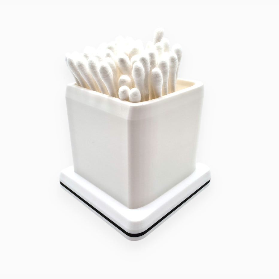 cube-shaped cotton swab holder with an open top that keeps swabs upright, by Dabdock