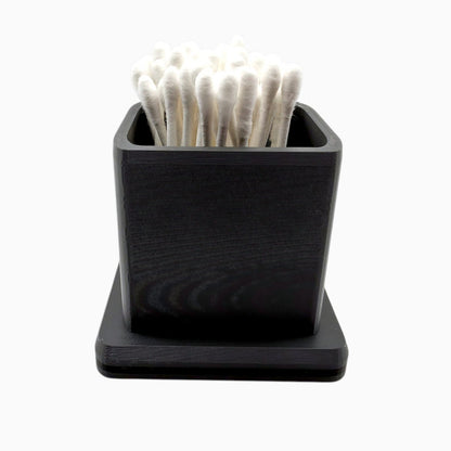 cube-shaped cotton swab holder with an open top that keeps swabs upright, by Dabdock