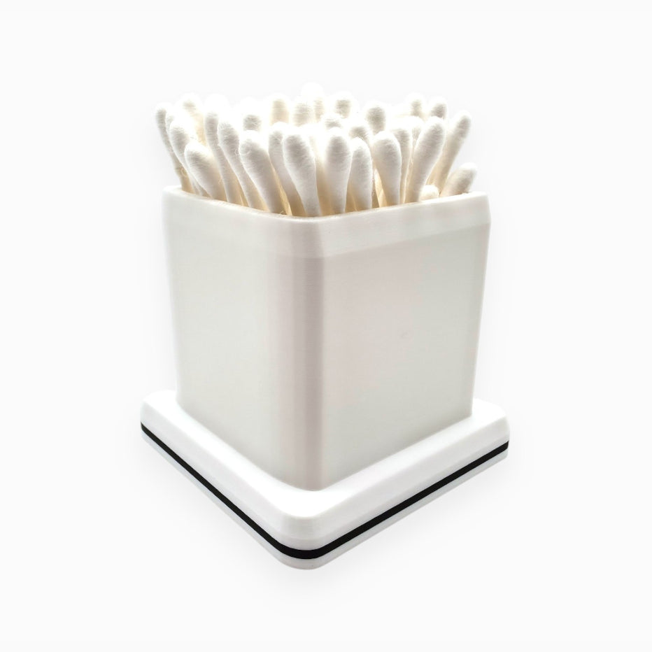 cube-shaped cotton swab holder with an open top that keeps swabs upright, by Dabdock