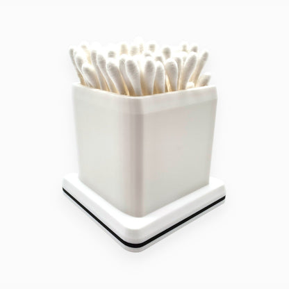 cube-shaped cotton swab holder with an open top that keeps swabs upright, by Dabdock